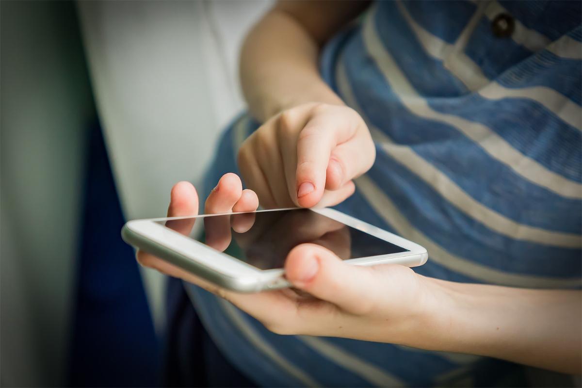Smartphone in a child's hand.