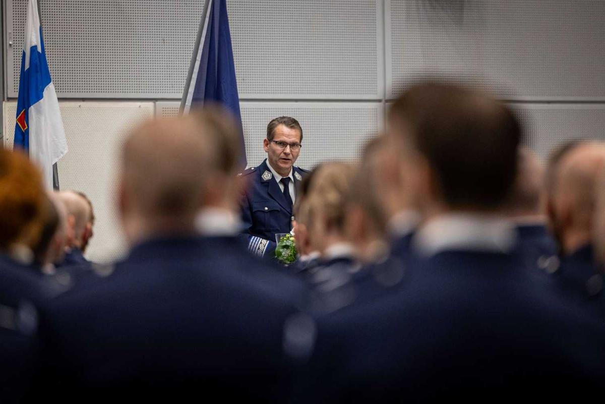 En polisman håller ett tal på ett podium.