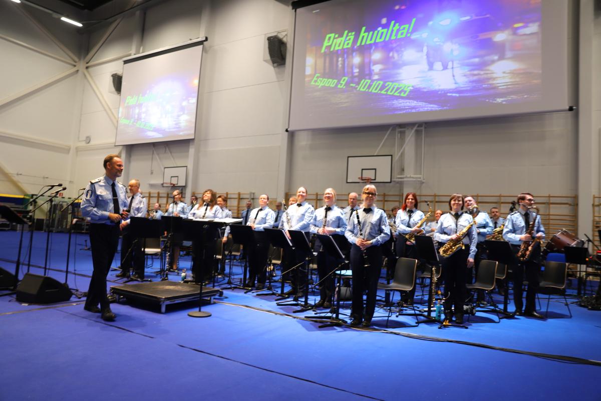 Poliisisoittokunta seisoo lavalla.