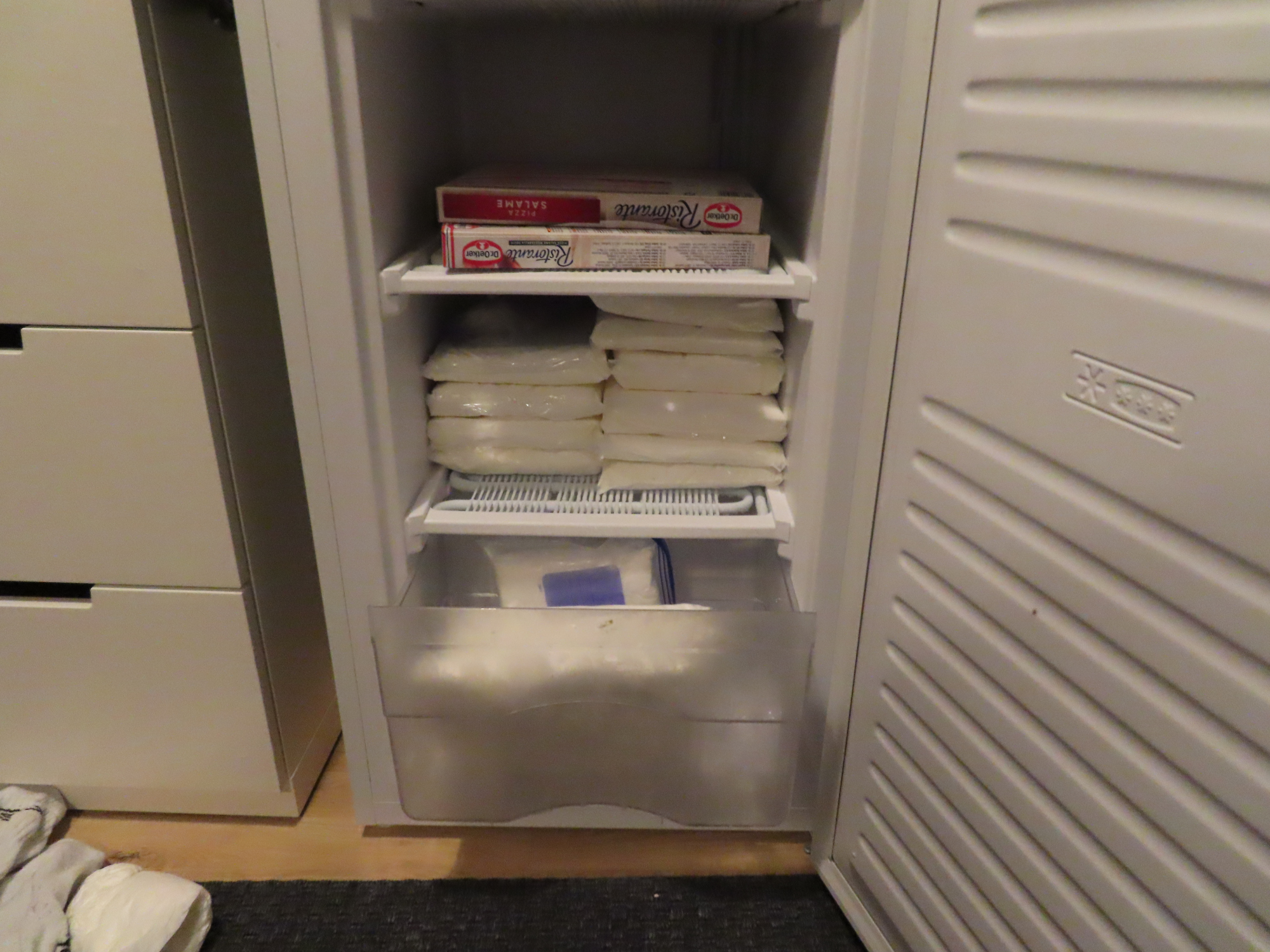 A photo taken from a police search showing bags of white powder stacked in a freezer.